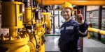 Power generation plant worker controlling crude oil and gas processing.